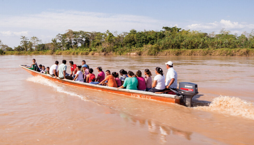 A group of people in a canoe going up the river