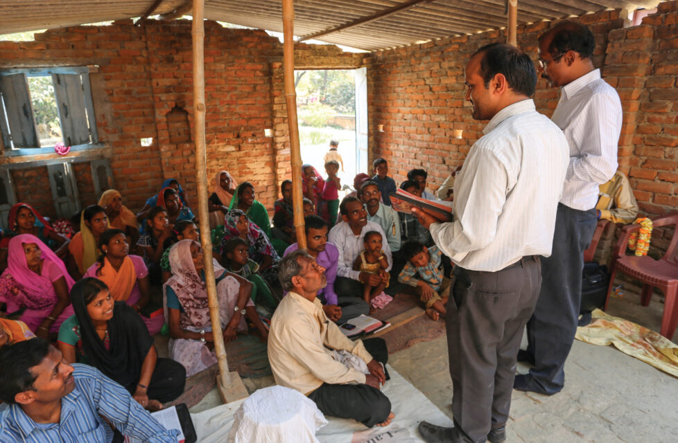 Two man leading a church service in a house