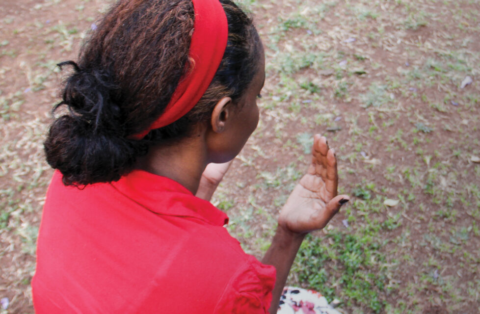 A woman kneeling and praying