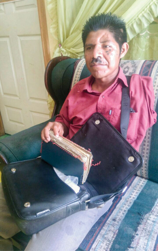 Man sitting and holding a bible 
