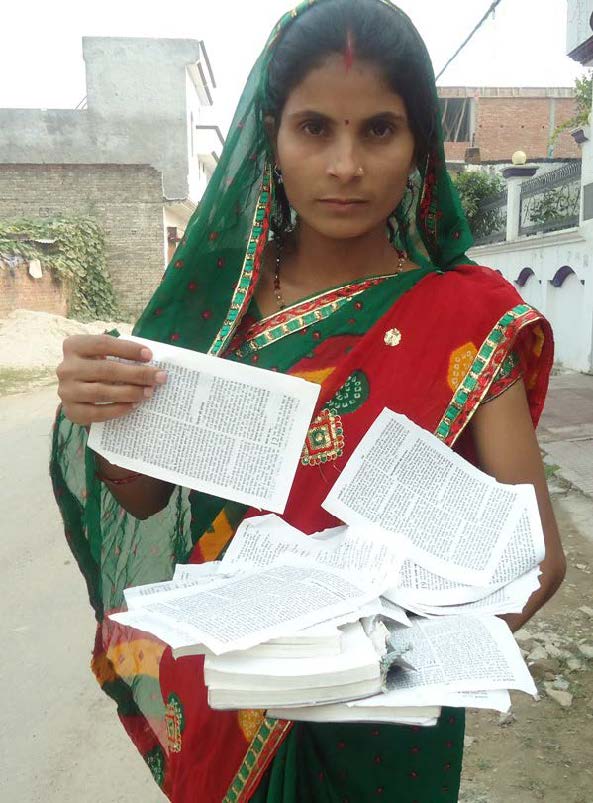 A woman holding pages of her Bible
