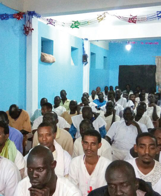 men sitting in a church service 