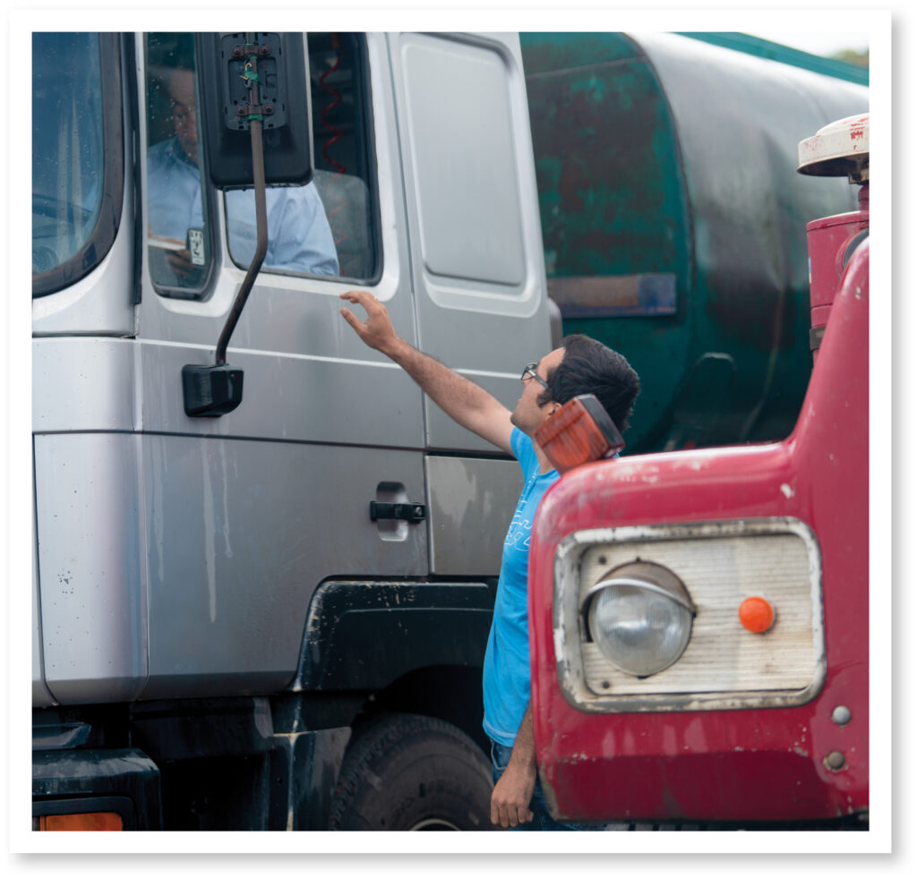 A man talking to another man in a truck