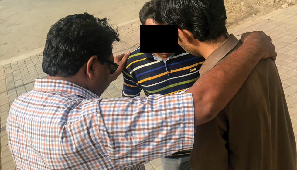 Three men praying together