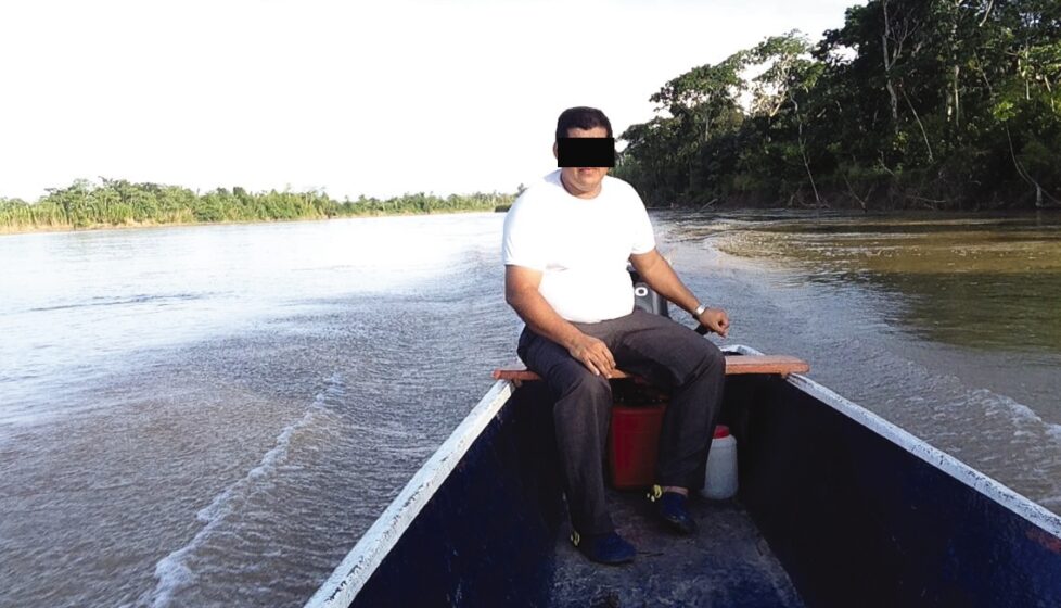 a an sits at the front of a small boat