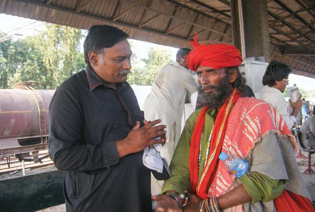 A man sharing the gospel with another man 