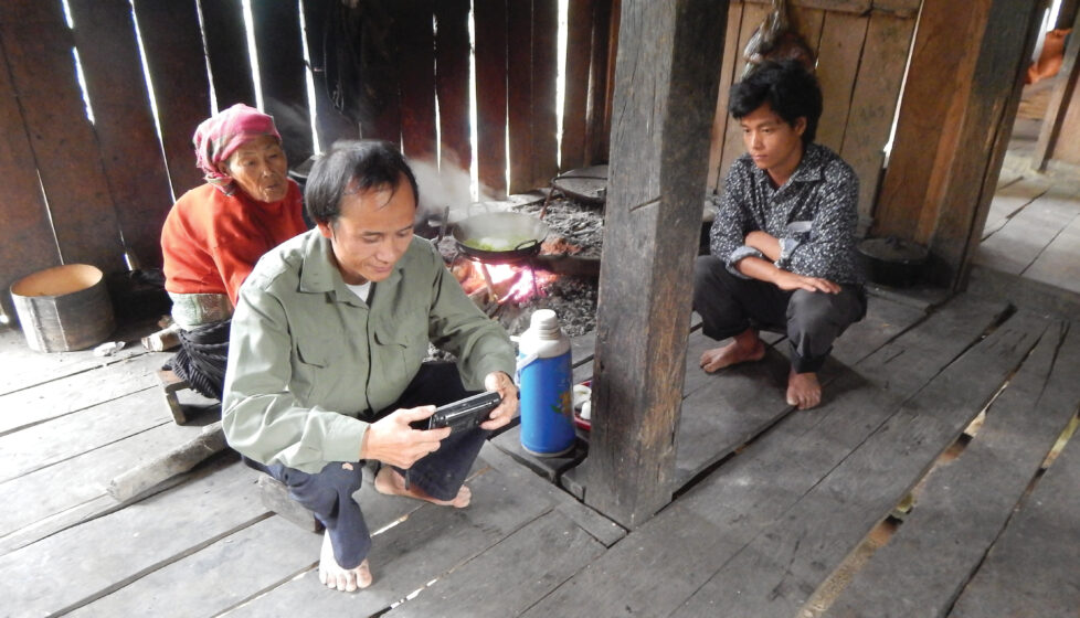 A family of three sit in their home reading