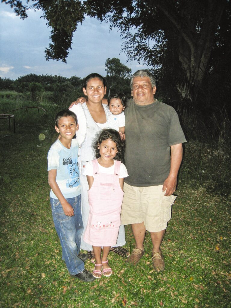 A family of five stand outside together 