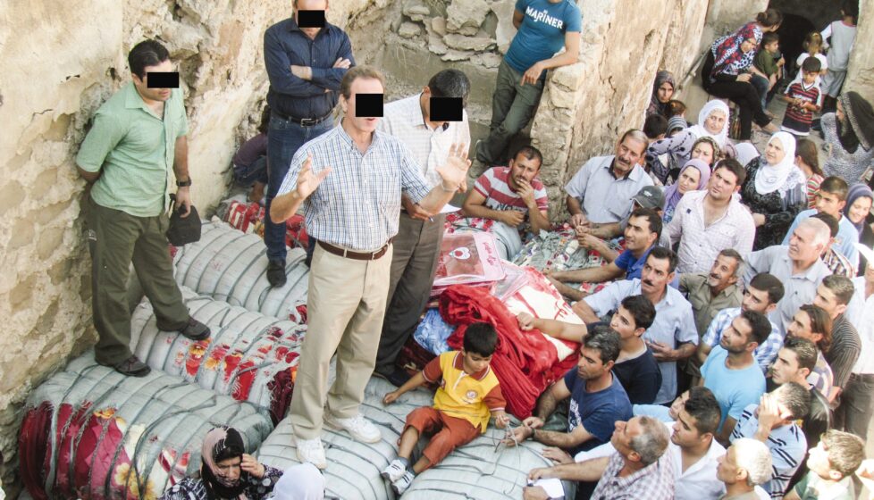 A man preaches to a large group of people outside