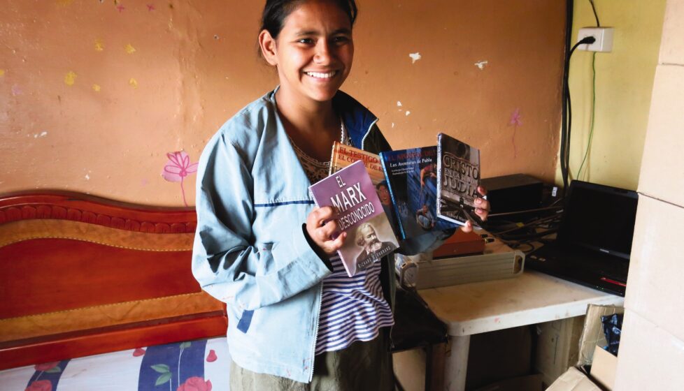 Colombian girl holds up literature