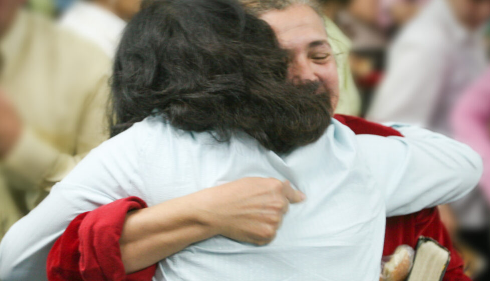 Two Women hugging at a church service