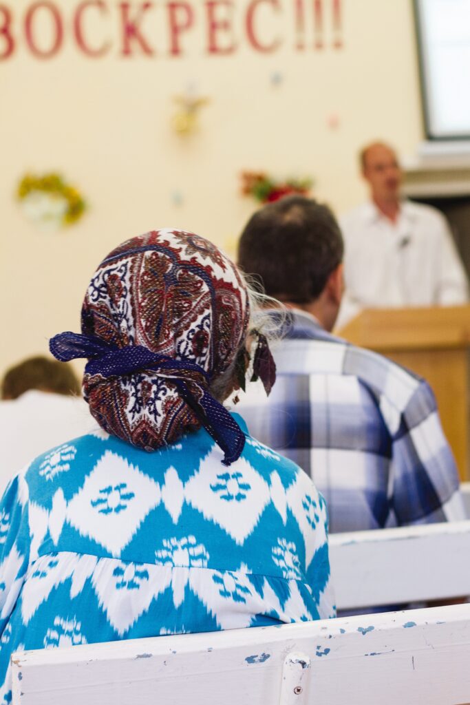 a woman sits in church 