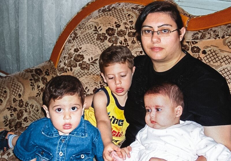 a picture of Pauline and her three children sitting on a couch