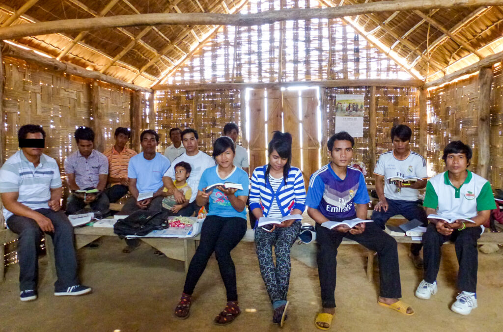 Group of Vietnamese believers sit reading Bibles