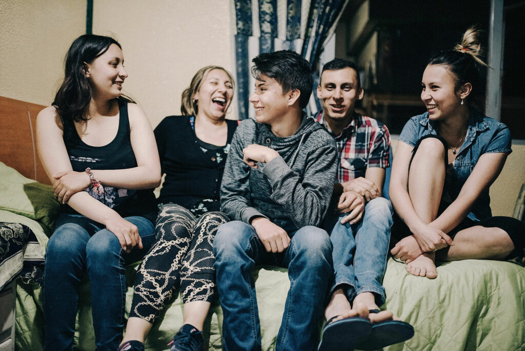 Colombian family laughing on a bed