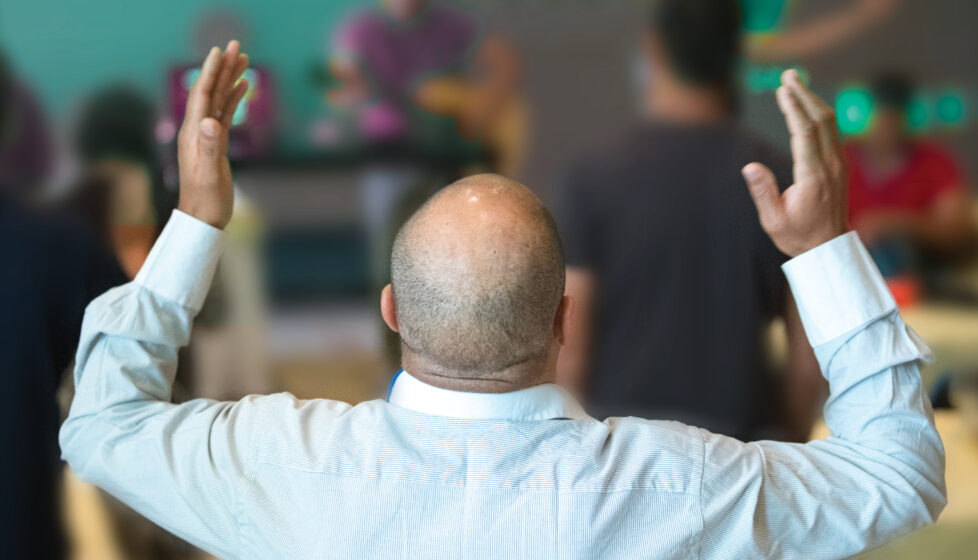 Man raising his hands in worship service