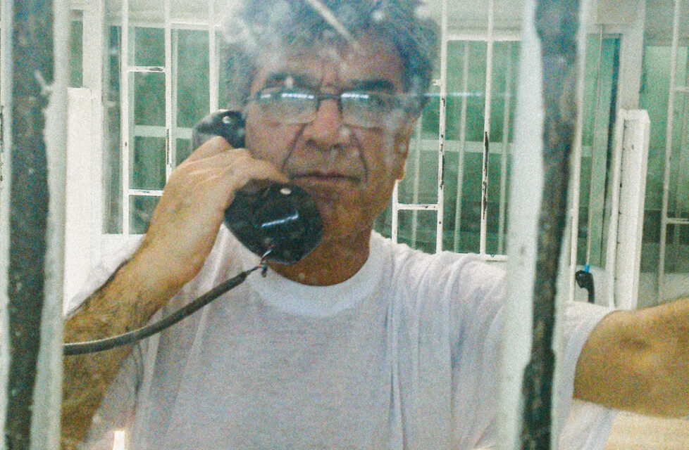 man on phone in jail