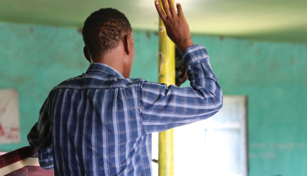 man raises his hand in worship