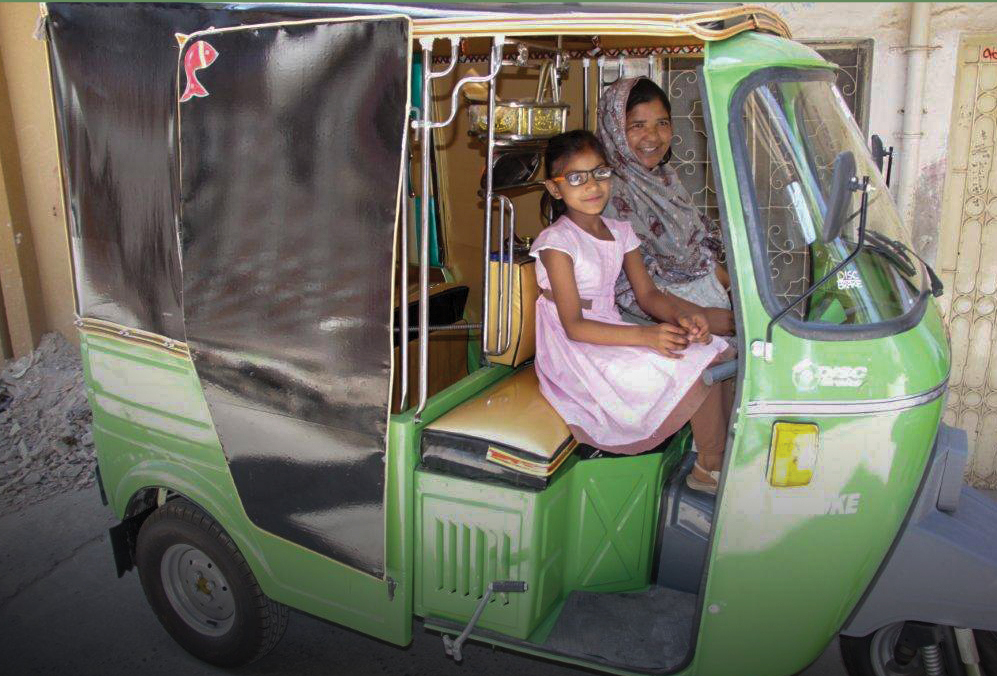 mother and daughter are pictured sitting inside a rickshaw
