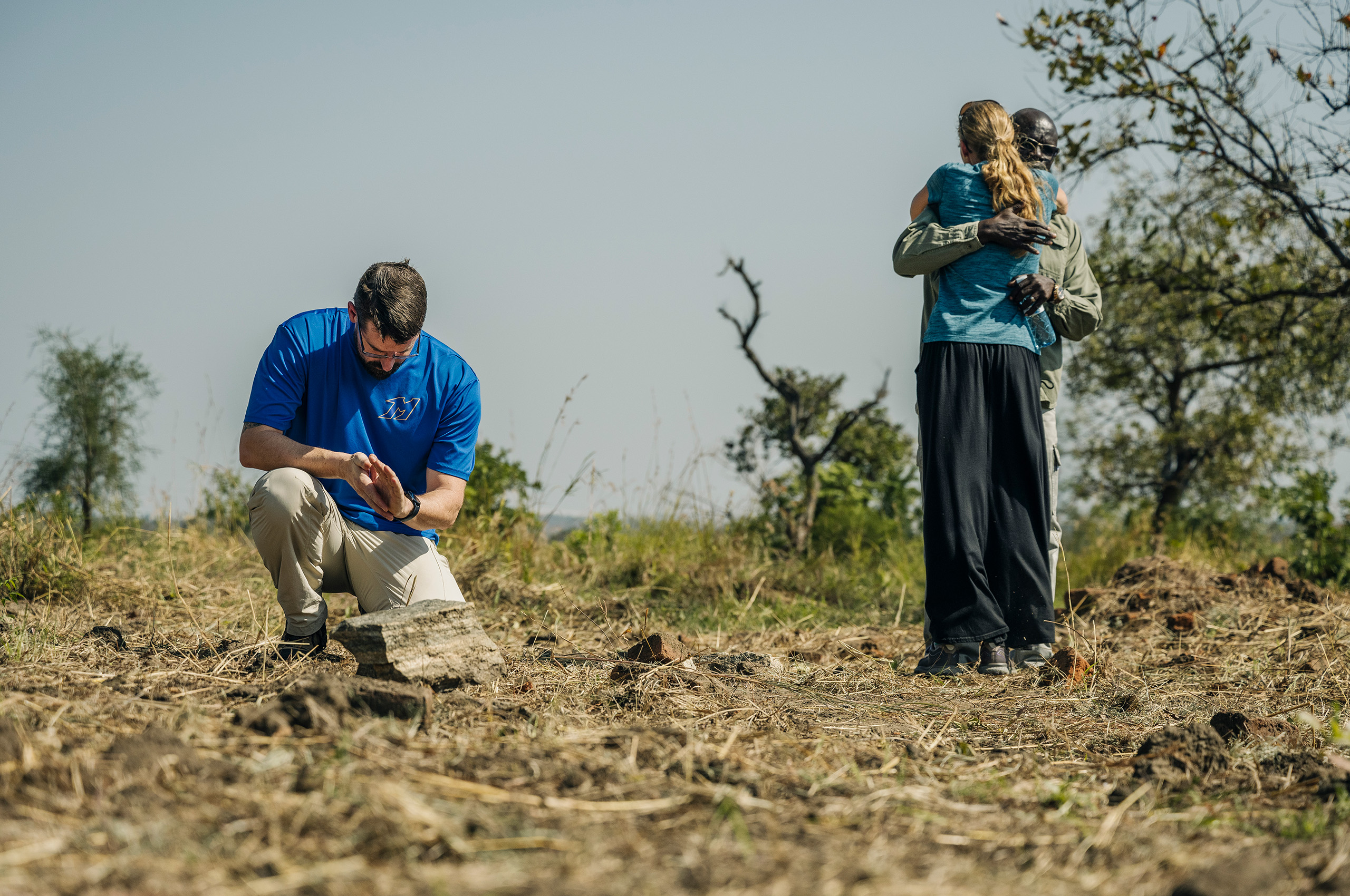 Americans in Uganda hugging a native Christian