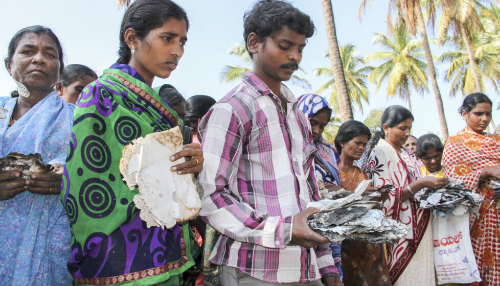 People clutching scraps of burnt Bibles. President's Letter Story.