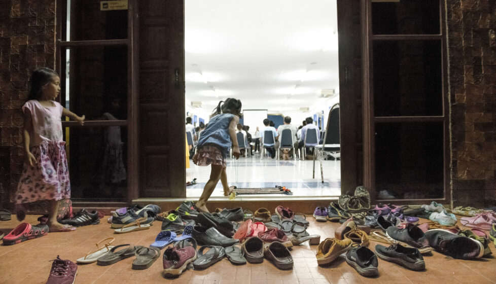 a group of children's shoes outside a door